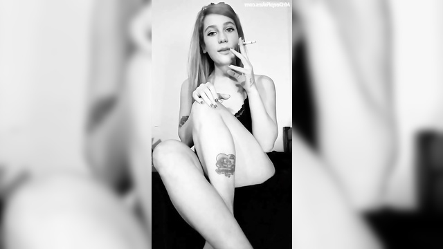 Adult Eden McCoy showed off her natural tits while smoking a cigarette