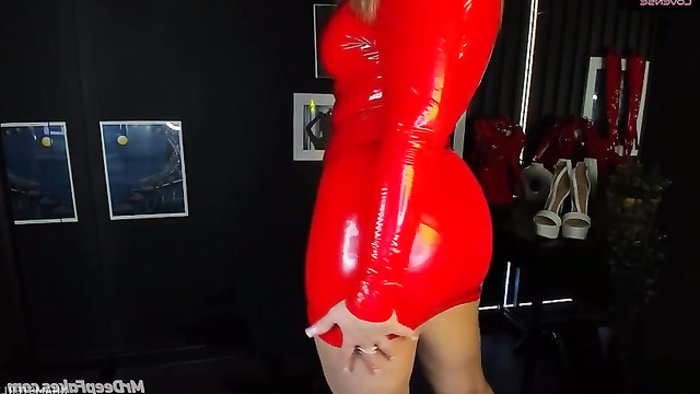 AI Jenny Carrera in a red latex dress that emphasizes her curvy figure